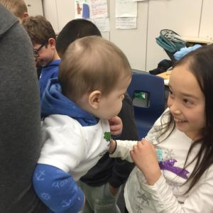 A girl interacts with a baby.