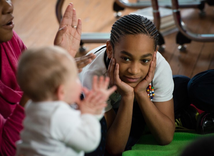 A student watches a baby clap