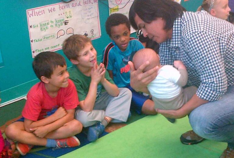 Father showing baby in a Roots of Empathy class